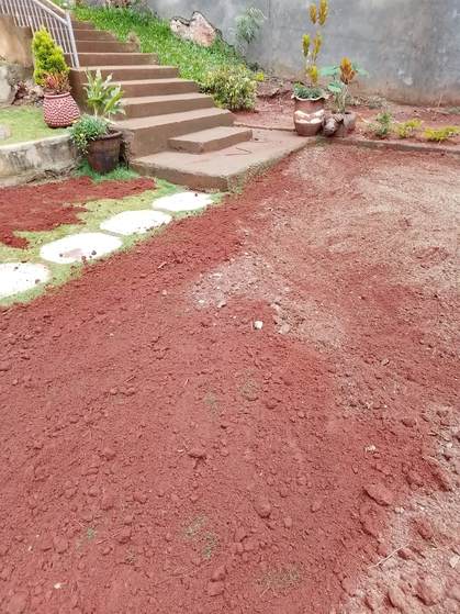 Red soil spread beside steps and stepping stones — by Kellyscappers Central